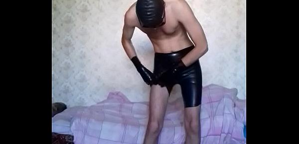  Guy putting on long latex shorts